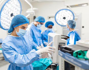 Anesthesiologist keeping track of vital functions of the body during cardiac surgery.