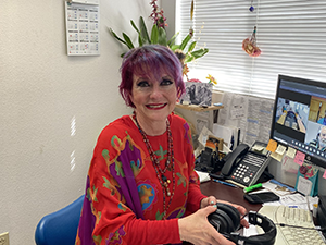 Kym BrownellPicture of smiling Kym Brownell sitting at her desk.