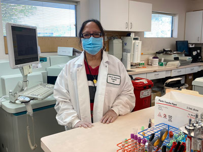 A female Lab worker standing inside our Lab.